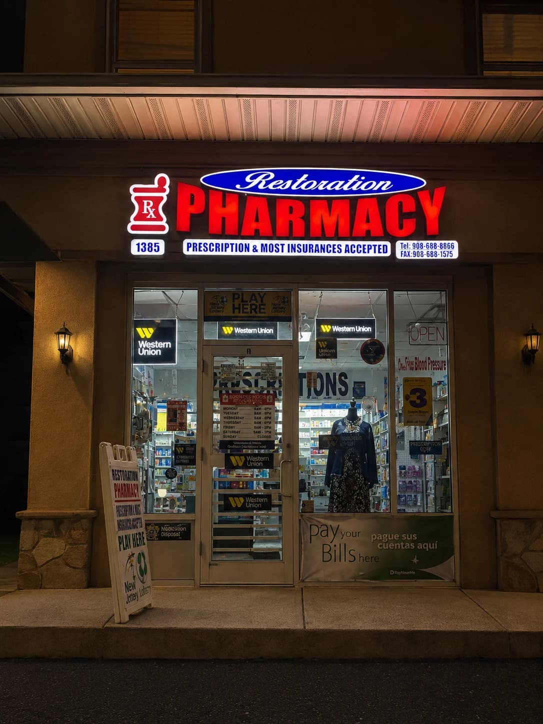 Front entrance of Restoration Pharmacy at night.